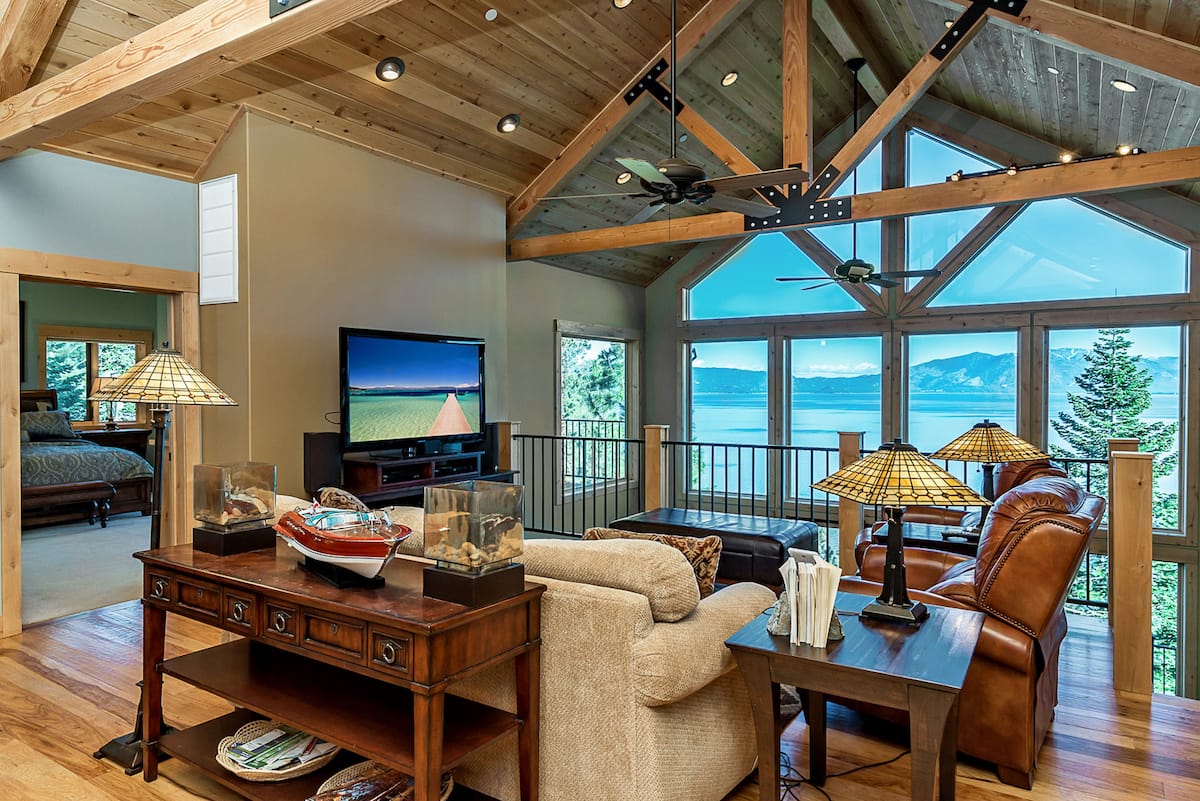  Inspired architecture and well-appointed furnishings make this jaw-dropping home the perfect blend of cozy and stunning: plush couches and pool tables are paired with four private decks and floor-to-ceiling windows with 180-degree views of the Rubicon Bay and Rubicon Peak.